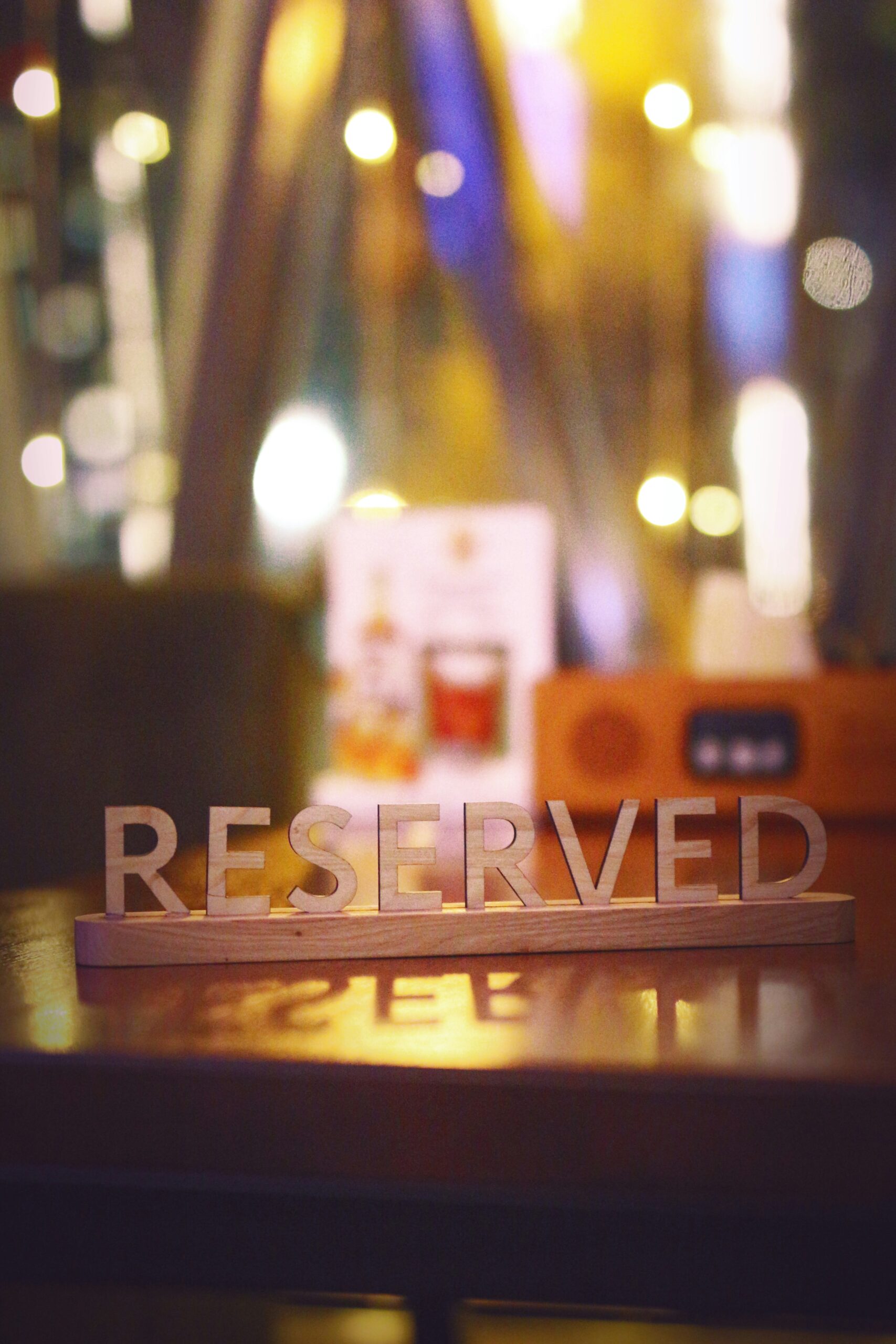 a wooden block that says reserved sitting on a table