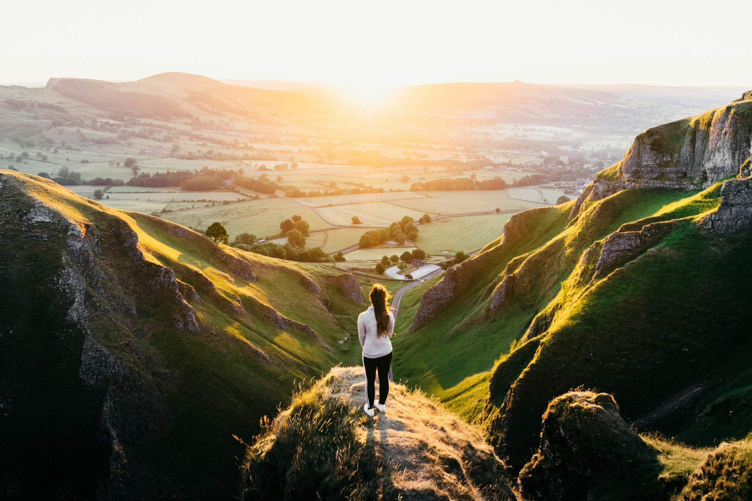 photo of woman standing on cliff